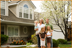 family in front of house